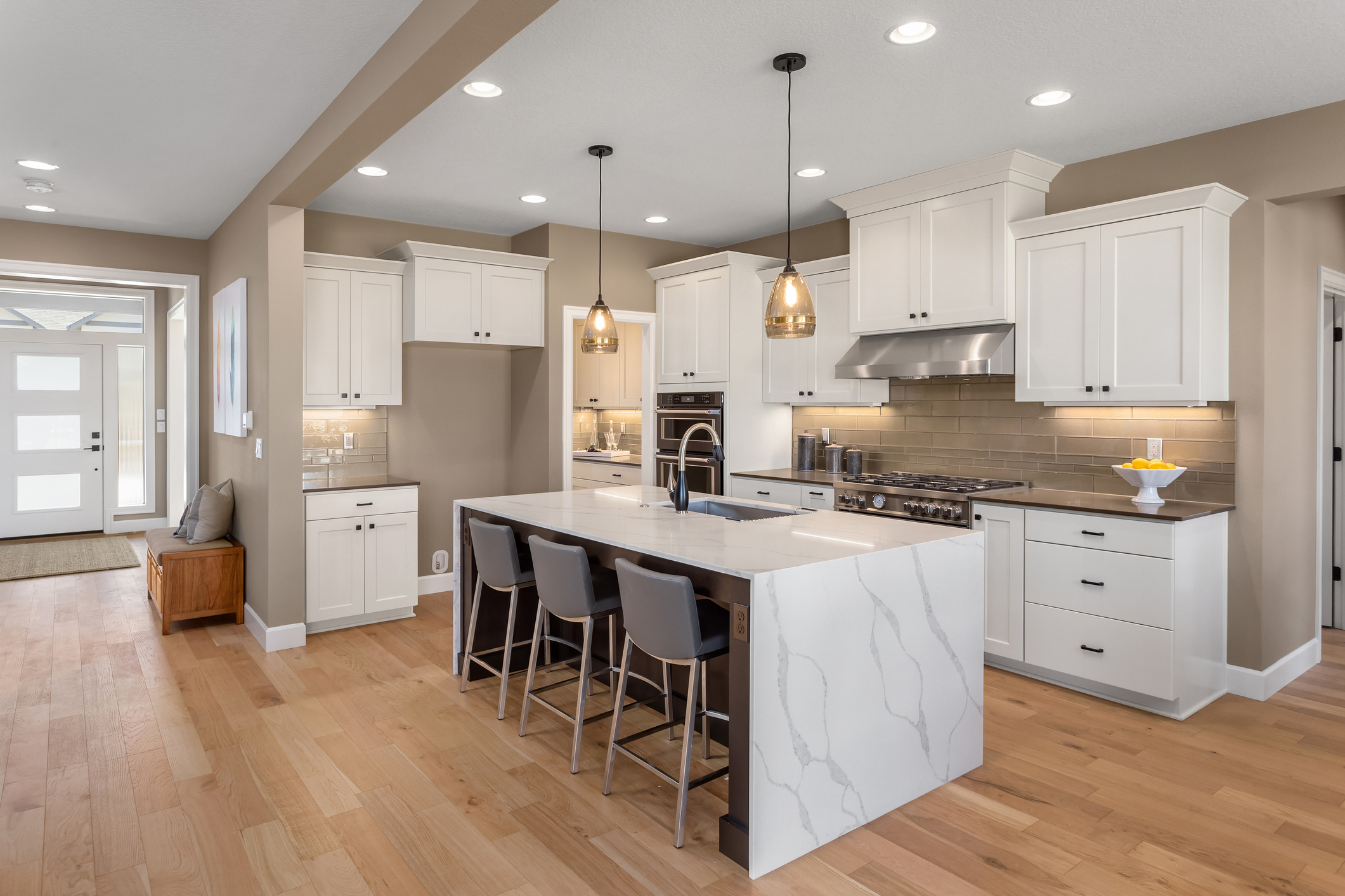 beautiful kitchen in new home with island, pendant lights, and hardwood floors. beautiful kitchen in new home with island, pendant lights, and hardwood floors.